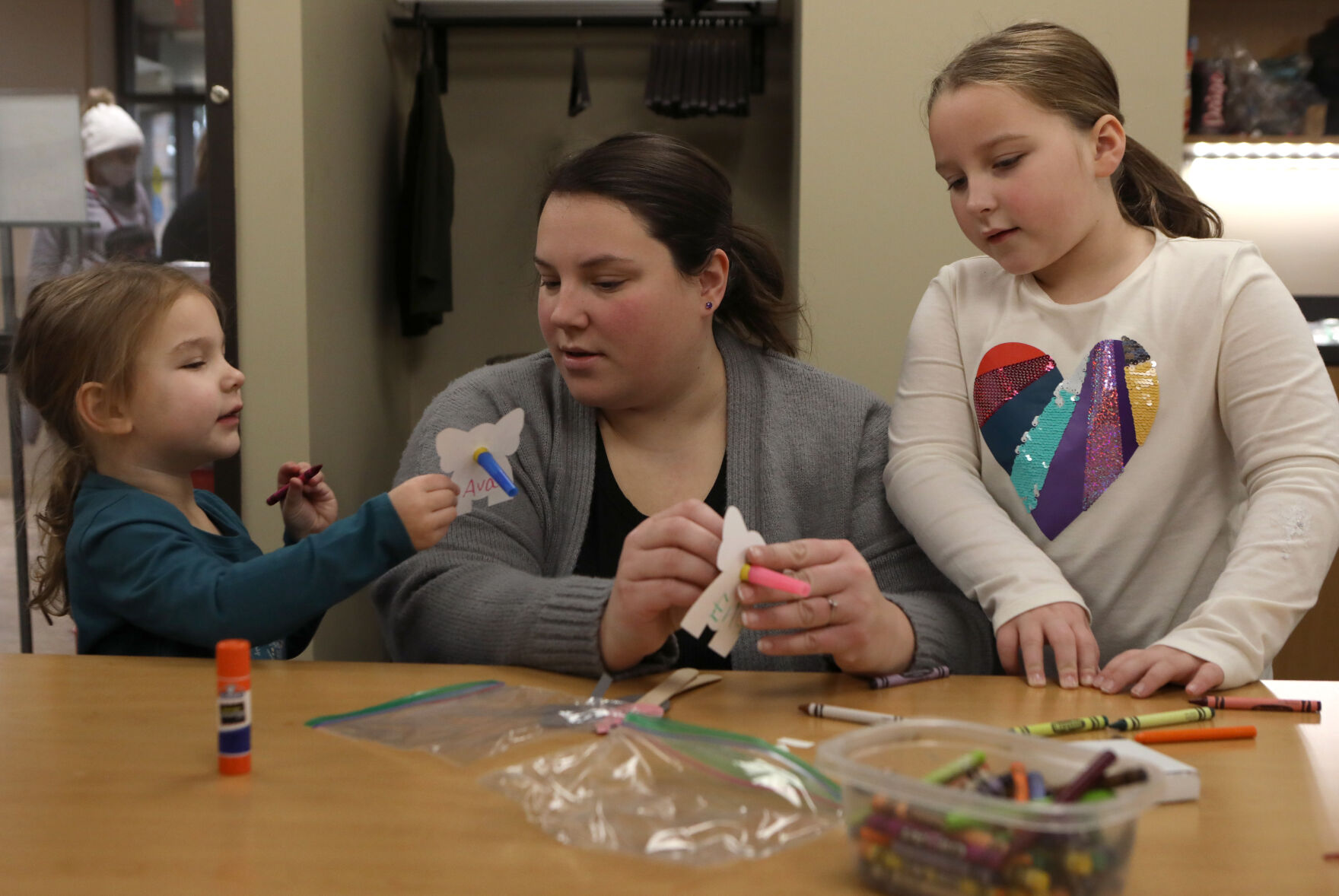 Ava and Ella Strohmeier decorate noisemakers